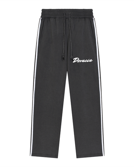 Black pants with white stripes and 'Doracia' branding on a white background