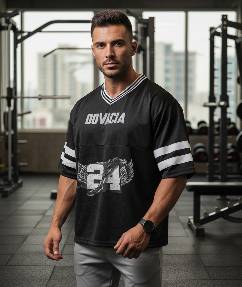 Man wearing a black sports jersey with 'Doviacia' branding in a gym setting
