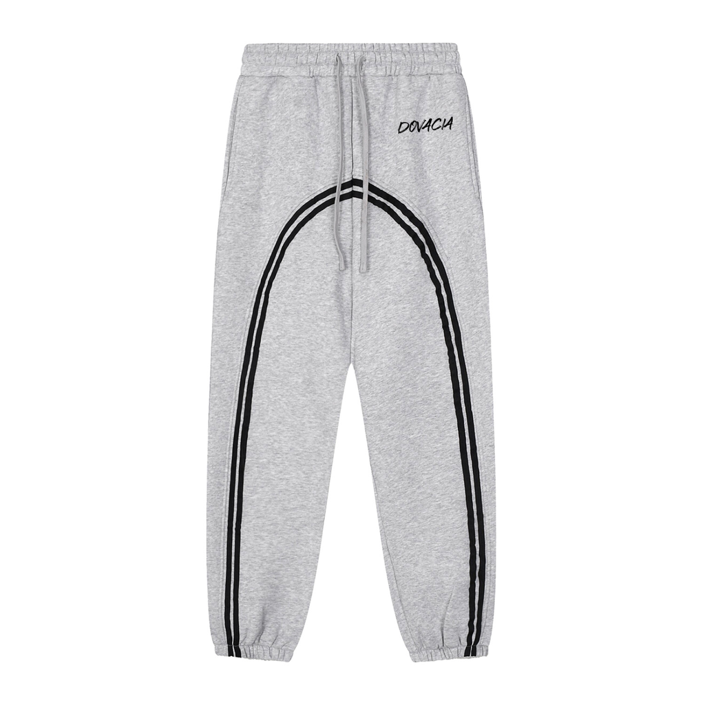 Gray sweatpants with black stripes and 'DOVICH' branding on a white background
