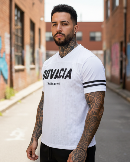 Man wearing a white t-shirt with 'Dovacia' branding in an urban setting