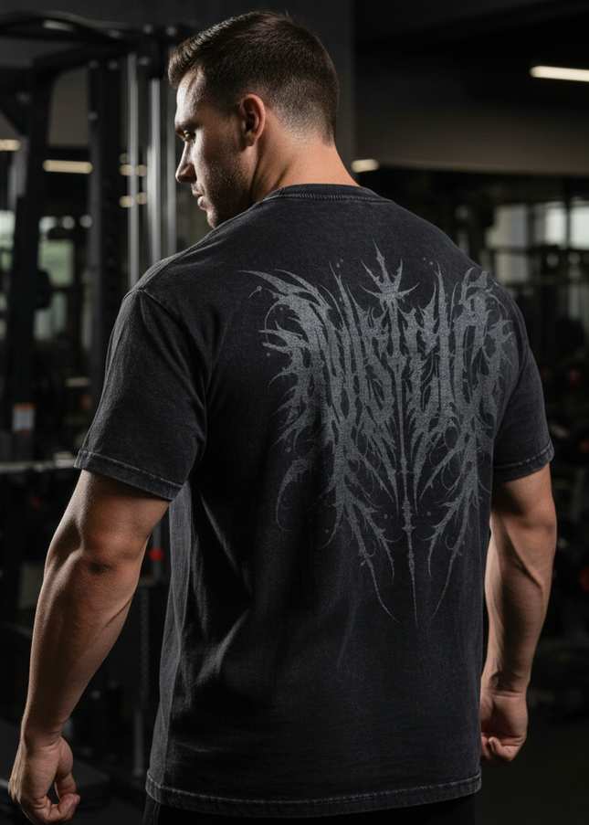 Man wearing a black t-shirt with a design on the back in a gym setting