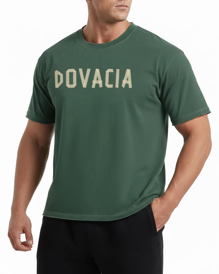 Man wearing a green t-shirt with 'DOVACIA' printed on it against a white background