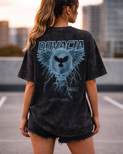 Person wearing a black t-shirt with 'DONVACIA' design on the back, standing on a rooftop.