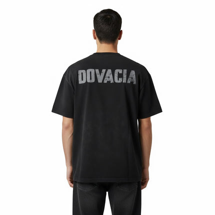 Person wearing a black t-shirt with 'DOVACIA' printed on the back against a white background