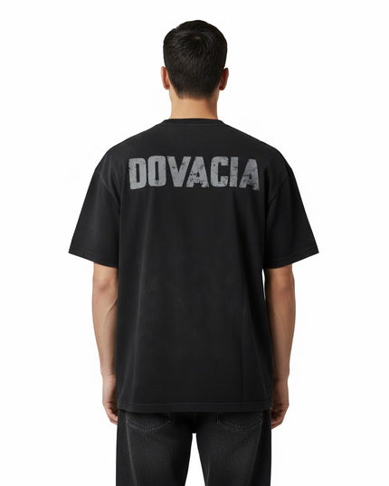 Person wearing a black t-shirt with 'DOVACIA' printed on the back against a white background