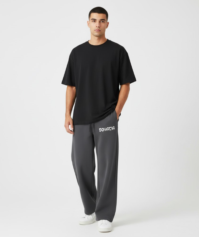 Man wearing a black t-shirt and gray pants with a brand logo on a white background