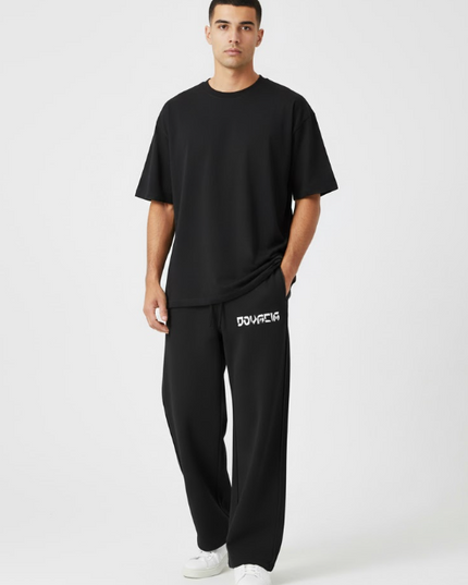 Person wearing a black t-shirt and black pants with a brand logo on a white background