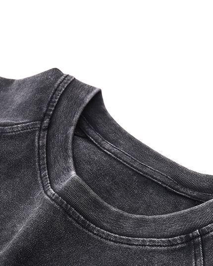 Close-up of a black denim shirt collar on a white background