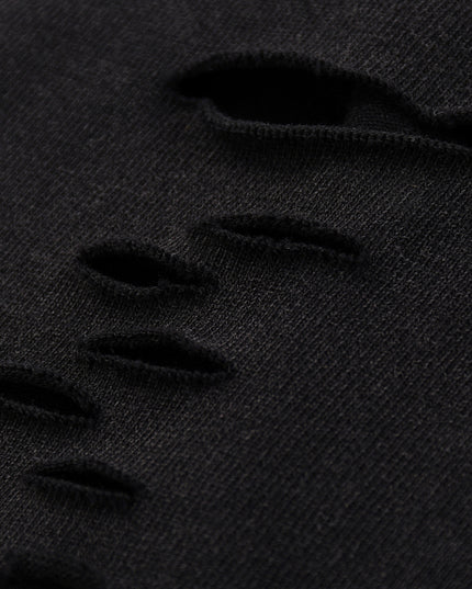 Close-up of black distressed denim fabric
