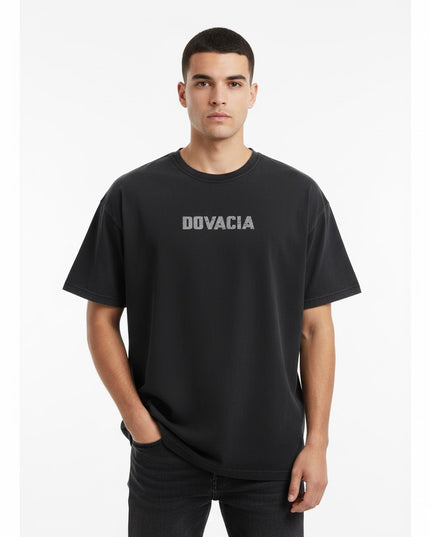 Man wearing a black t-shirt with 'DOVACIA' logo on a white background
