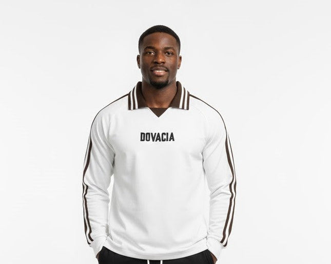 Man wearing a white tracksuit with 'DOVACIA' branding on a white background