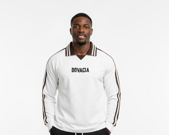 Man wearing a white tracksuit with 'DOVACIA' branding on a white background