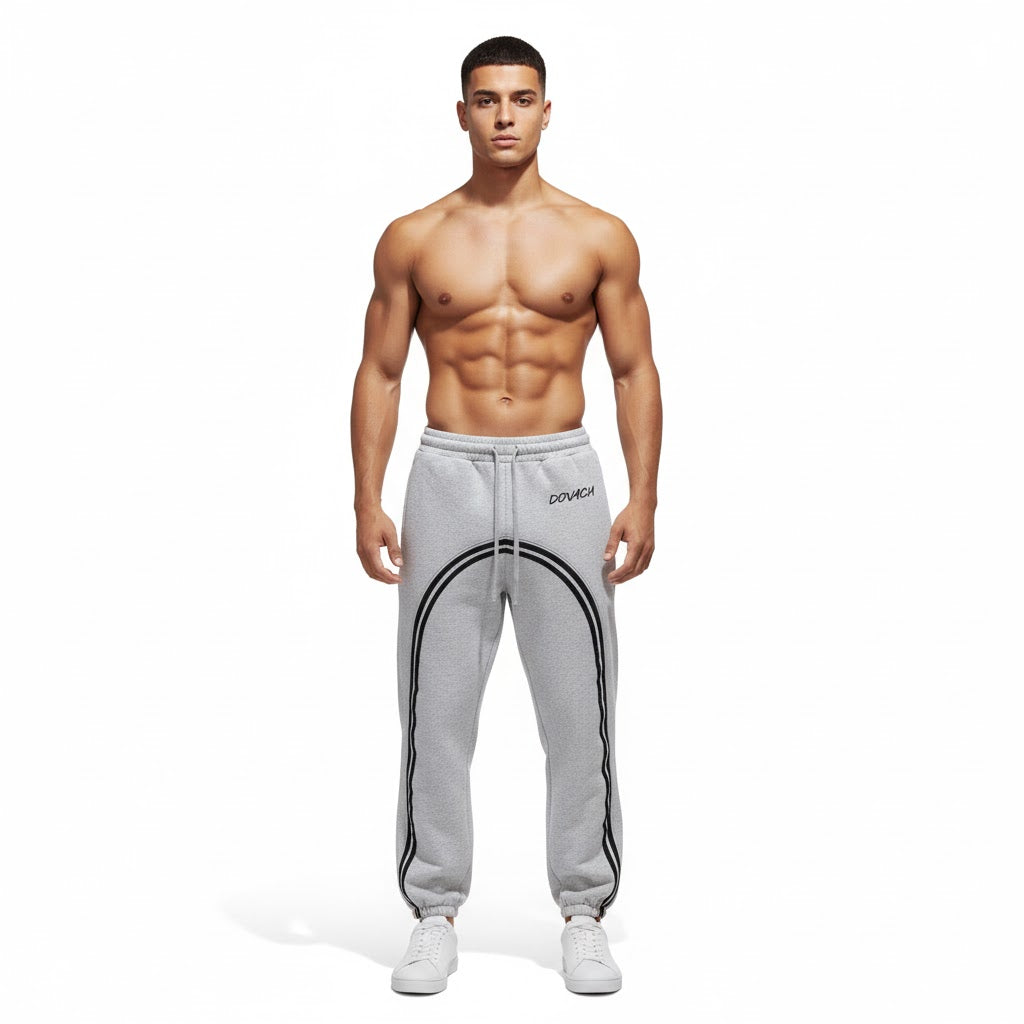 Man wearing gray sweatpants with a brand logo on a white background