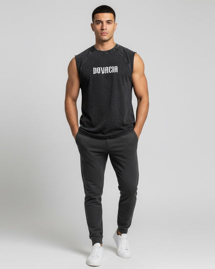 Man wearing a black sleeveless shirt with 'BOVACIA' logo and black pants on a white background